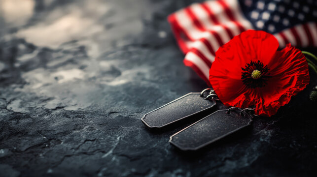 Military dog tags and a vibrant red poppy rest on a dark, textured surface, with a folded American flag in the background, symbolizing remembrance and sacrifice