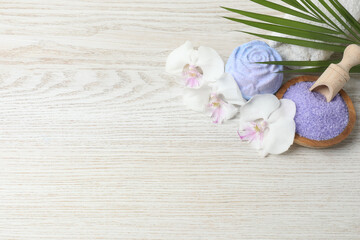 Beautiful spa composition with sea salt, soap bar and flowers on, closeup