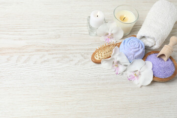 Beautiful spa composition with sea salt, soap bar and flowers on, closeup