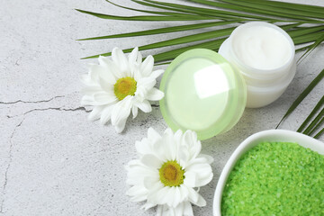 Beautiful spa composition with sea salt, soap bar and flowers on, closeup