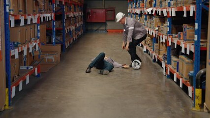 Coworkers are helping workers who have accidents at work in a warehouse.