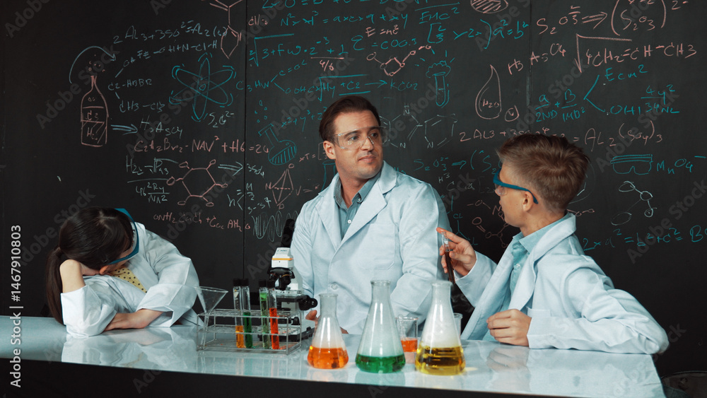 Poster creative teacher pointing chemistry at blackboard while talking to highschool boy at table with micr