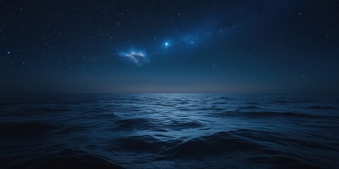 Deep Blue Ocean Waves Gently Rolling Under a Clear, Star-Studded Night Sky with Distant Nebulae, Representing the Calmness and Majesty of the Night Sea.
