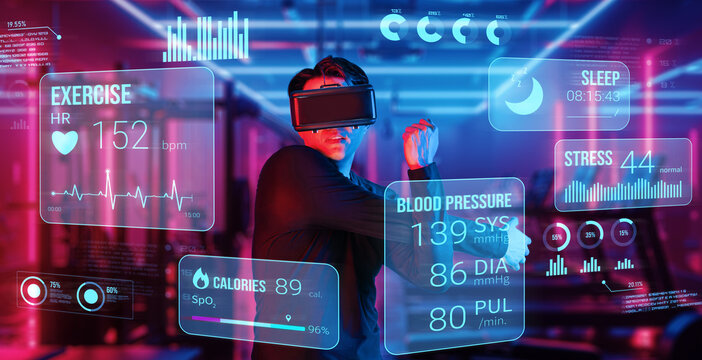Happy asian man with VR glasses playing fitness while exercising at fitness. Male model using augmented reality and artificial intelligence to plan exercise plan while looking at hologram. Ingenuity.