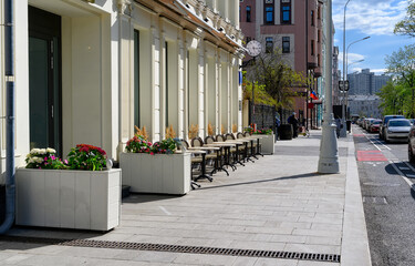 Tverskoy Boulevard with tables of cafe in center of Moscow in Russia. Cozy cityscape in Moscow. Architecture and landmarks of Moscow.