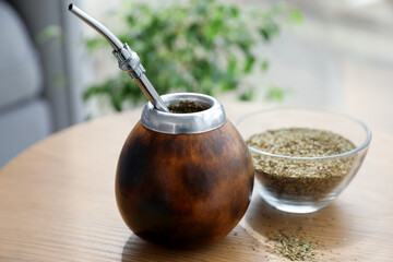 Traditional yerba mate tea on wooden table indoors