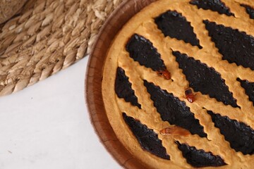 Cockroaches crawling on pie on light table, top view
