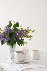 A lovely tea setup with lilac flowers, perfect for relaxation and enjoying serene moments of tranquility
