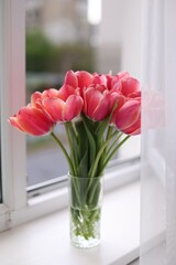 Bouquet of beautiful tulips on window sill