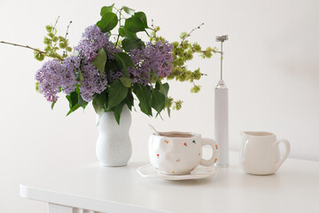 A lovely tea setup with lilac flowers, perfect for relaxation and enjoying serene moments of tranquility