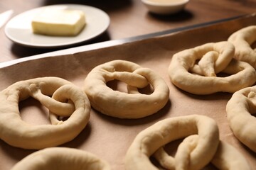 Uncooked pretzels and ingredients on table, closeup