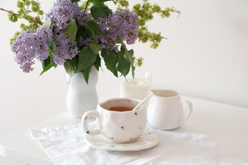 A lovely tea setup with lilac flowers, perfect for relaxation and enjoying serene moments of tranquility