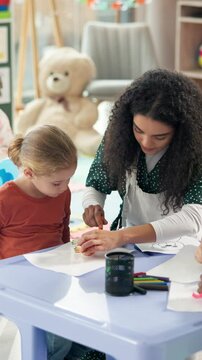 Teacher, kid and helping with drawing for activity, creativity or learning together in classroom. Woman, educator or assist with toy for tracing, fine motor skills or education at kindergarten school