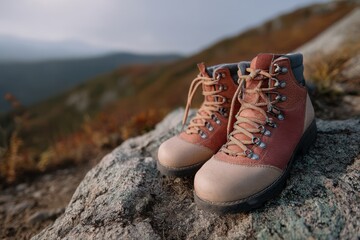 Naklejka premium Outdoor Leather Boots on a Rocky Mountain Top for Hiking Adventures and Exploration Gear