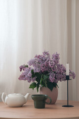 A Serene Still Life Composition Featuring Beautiful Lilac Flowers and an Elegant Teapot