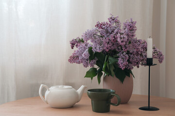 A Serene Still Life Composition Featuring Beautiful Lilac Flowers and an Elegant Teapot