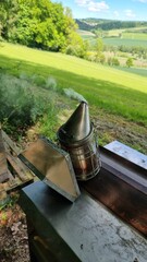 Smoker, at the beehive at the edge of the forest