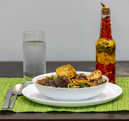 Traditional black bean soup with noodles and pork ribs, rustic Brazilian food known as sopa preta or sopa de benzedeira