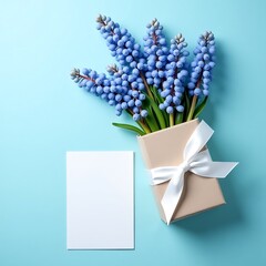 Blank white wedding card mockup, Muscari Gift Set with Blue Ribbon and Greeting Card on Pastel Background, top view close-up. Mockup template with copy space design of greeting card, textured paper