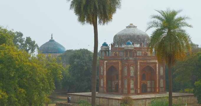 New Delhi, Delhi, India. Doves birds flying above Babur's Tomb near The Humayun's tomb. Famous place is Tomb of Mughal emperor, Mirza Nasir al-Din Muhammad commonly known as Humayun situated in Delhi