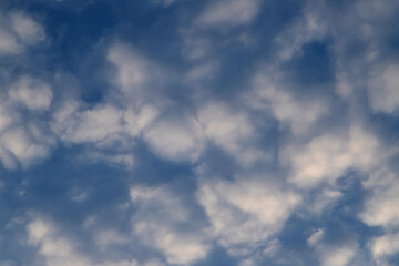Soft white clouds in a tranquil blue sky