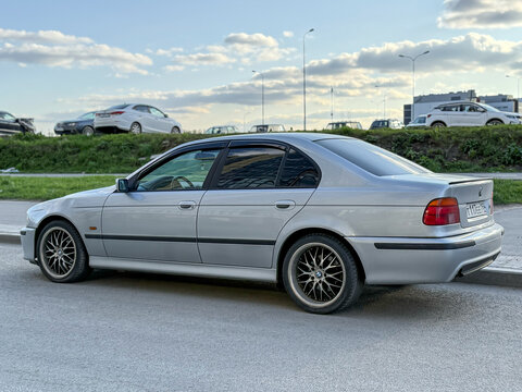 Silver car BMW E39 5-series 530d at the city street. BMW E39 5-series 530d parked on street. Exterior of a BMW E39 car. Germany classic car. 