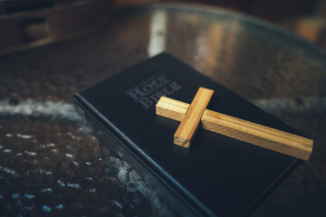 wooden cross on holy Bible. It is a light and a hope