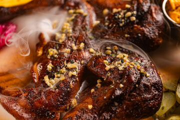 Closeup of roasted grilled whole chicken served at restaurant