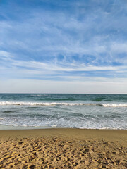 beautiful landscape on the coast of the beach and sea waves against the background of the blue sky