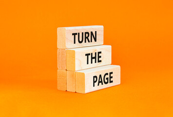 Turn the page symbol. Concept words Turn the page on beautiful wooden block. Beautiful orange table...