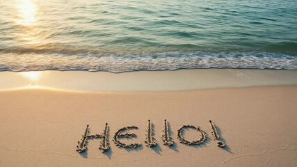Hello is written in the sand on a sunny day at the beach. Good for vacation, travel, summer greeting card and welcome concept with ocean wave background.