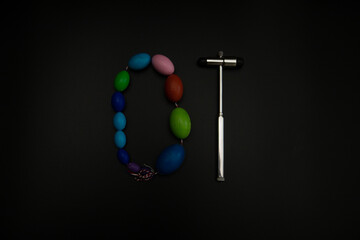 tuning fork C 128 on a black background with gradation and otorhinoscope and neurological hammer