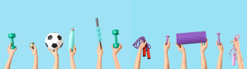 Female hands with sports equipment on blue background