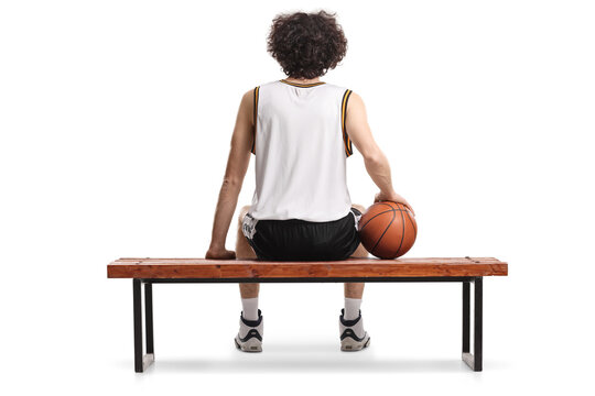 Rear view shot of a basketball player sitting on a bench