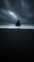 Dramatic black sand beach with rock formations under stormy skies