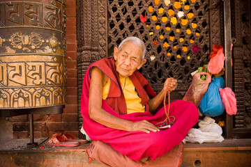 Monk praying prayer beads