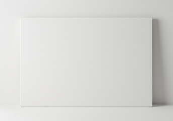 Blank white canvas leaning against white wall, empty display space perfect for mockups, presentations, and adding text