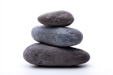 Zen like stack of smooth stones in varying shades of gray symbol of balance and tranquility on white