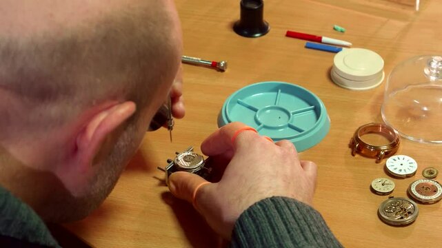 Dedicated clockmaker meticulously disassembles intricate clock mechanism