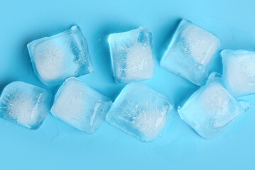 Many frozen ice cubes on blue background