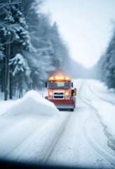 Obraz premium red truck driving down a snow covered road
