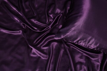 Fototapeta premium Luxury purple silk bed linens as background, top view