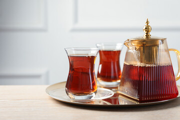 Tasty Turkish tea served on wooden table. Space for text