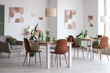 Interior of restaurant with tables, flowers and paintings