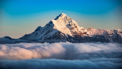 Obraz premium a snow capped mountain peak emerges from a sea of clouds bathed in soft light dramatic and serene