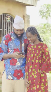 local young father and daughter using mobile phone for the first time