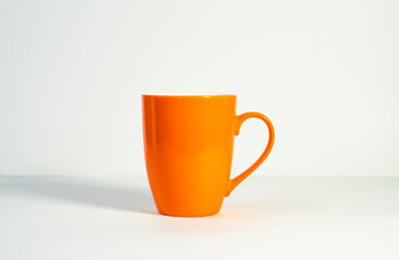 Modern Orange Mug for Coffee or Tea on a White Background