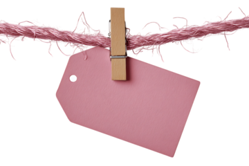 Pink tag hangs from twine with wooden clothespin against trasparent background