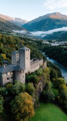 Medieval castle on a cliff overlooking a river in a mountainous valley landscape with fog, autumn colors and green forests