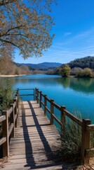 Fototapeta premium Scenic Lake View with Wooden Dock and Clear Blue Sky on a Sunny Day